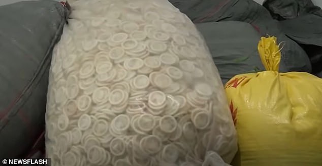 Police seize 324,000 used condoms as they bust factory repackaging them and selling back to the public (photos)