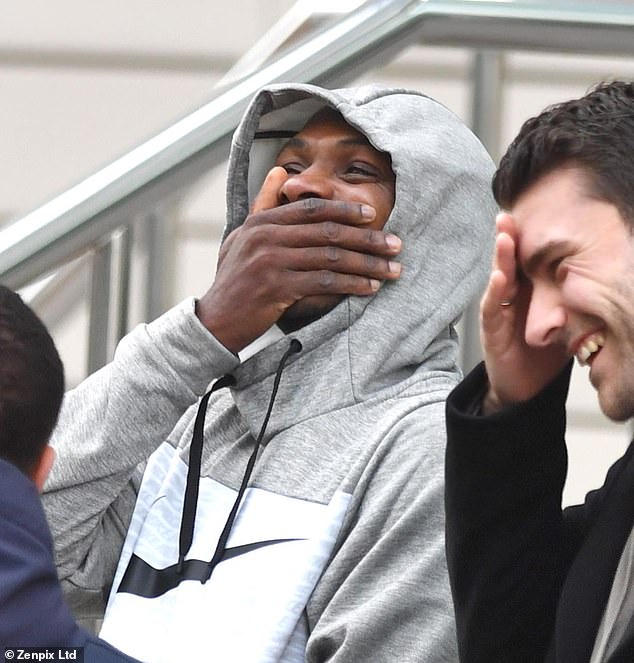 The Nigerian was laughing and joking away with friends on an overcast Monday morning