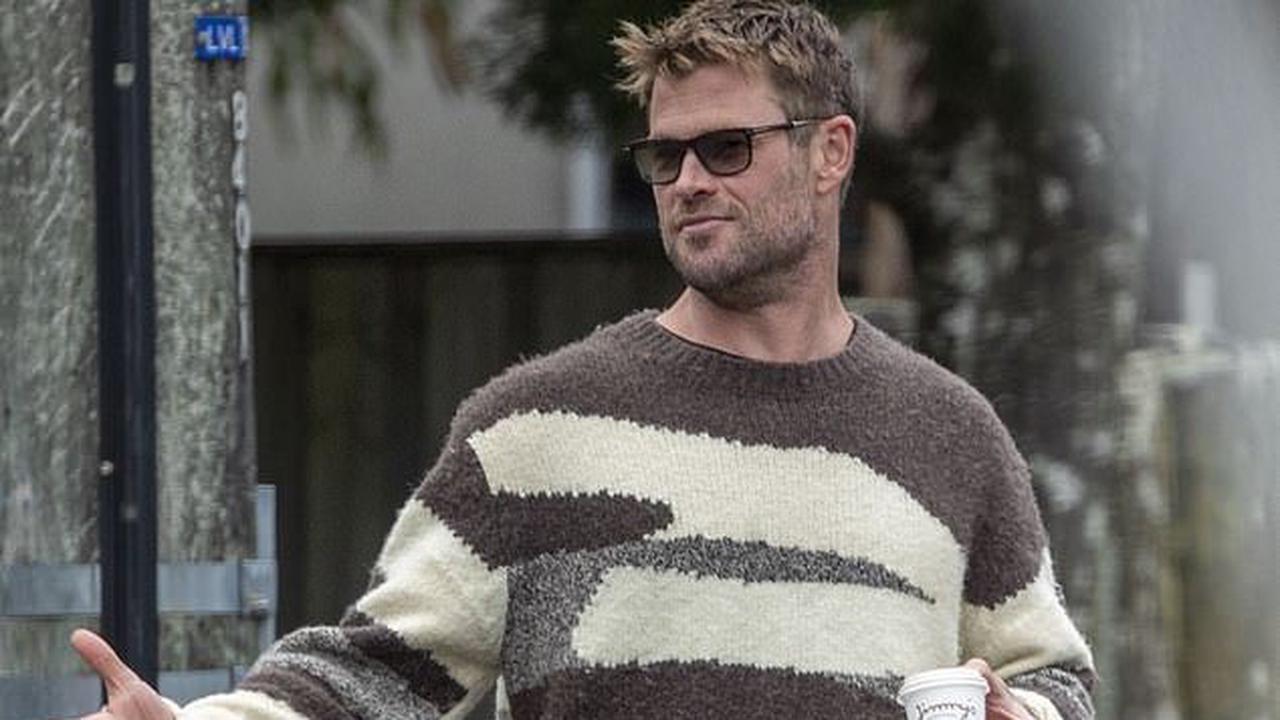 Chris Hemsworth attempts to go incognito in a woolly jumper and dark sunglasses as he enjoys a coffee with brothers Liam and Luke in Byron Bay