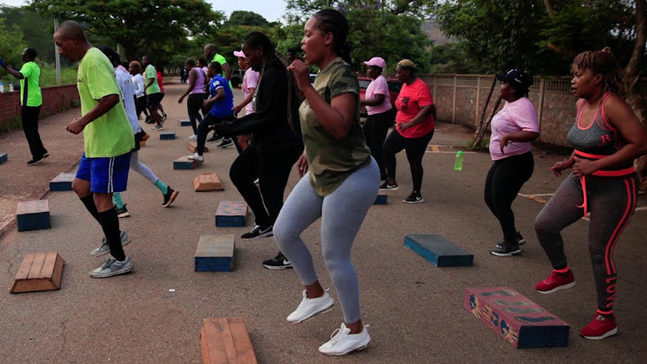 Zimbabweans are working out at a cemetery