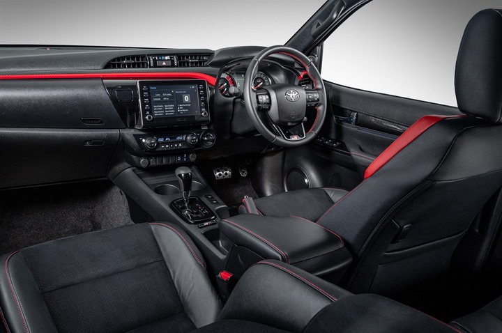 Red accents and Alcantara seat inserts denote the 