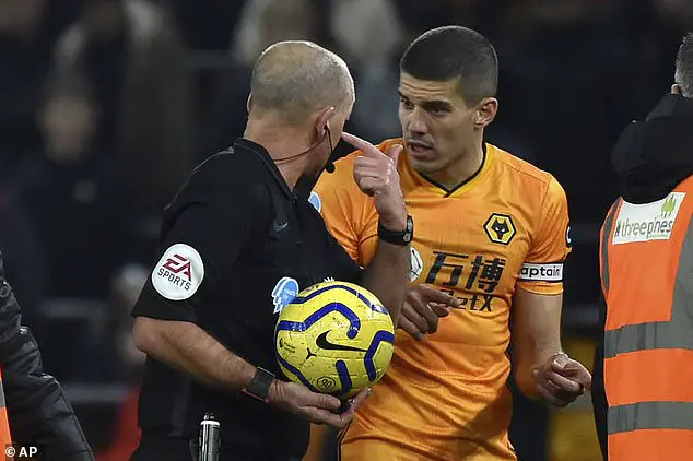 Mike Dean (left) and Conor Coady (right) had a heated VAR chat during a Premier League game