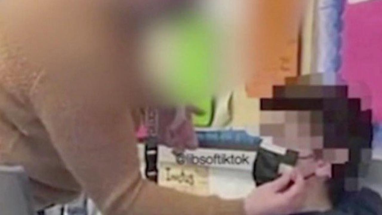 Fury as shock photo shows teacher taping mask to young student’s face