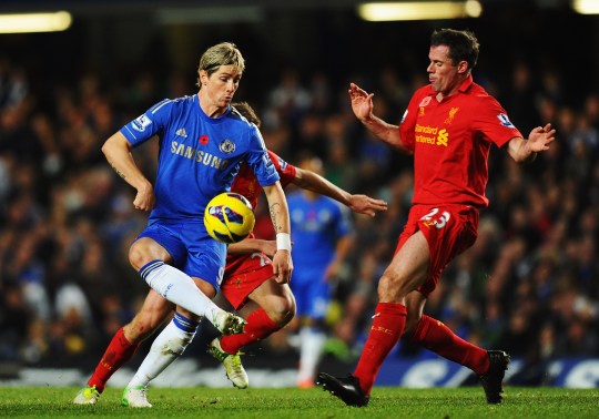 LONDON, ENGLAND - NOVEMBER 11:  Fernando Torres of Chelsea holds off the challenge of Jamie Carragher of Liverpool during the Barclays Premier League match between Chelsea and Liverpool at Stamford Bridge on November 11, 2012 in London, England.  (Photo by Mike Hewitt/Getty Images)