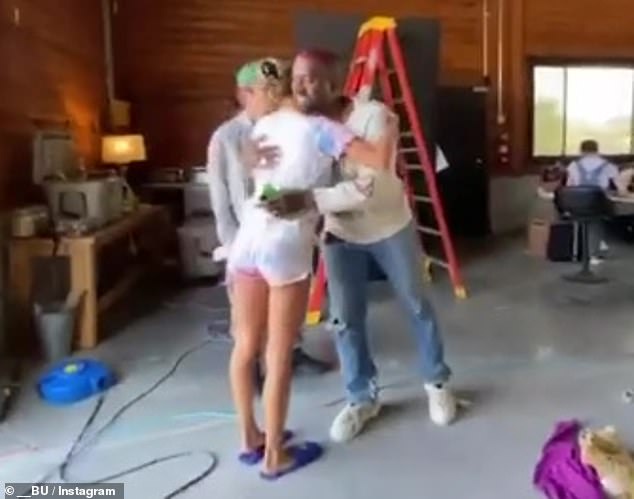 Hugging it out: Justin can be seen approaching Kanye with open arms before lovingly embracing his longtime pal with a hug