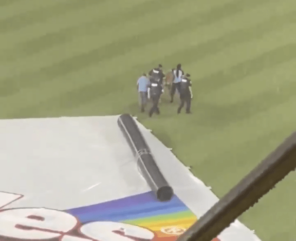 Streaker Uses Tarp As Slip And Slide Gets Stuck In Tarp S Cylinder Before Getting Handcuffed At Reds Nationals Game S Rain Delay Opera News