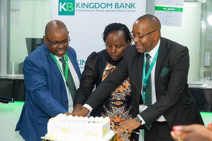 May be an image of one or more people, dais and text that says 'KB A Subsidiary of he Co-operative Bank of Kenya KINGDOM BANK TAMURANG m-pesa m- pesa LoU8ShG 85158 우의 OESIa SUPE KIN ubsi ٦ 目'
