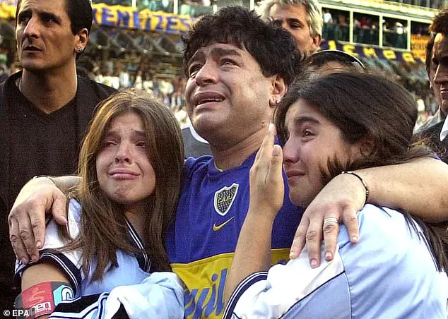 Diego Maradona and his daughters Dalma Nerea (left) and Giannina Dinora (right) are overcome with emotion during an event in Maradona's honor at the "La Bombonera" stadium on November 10, 2001