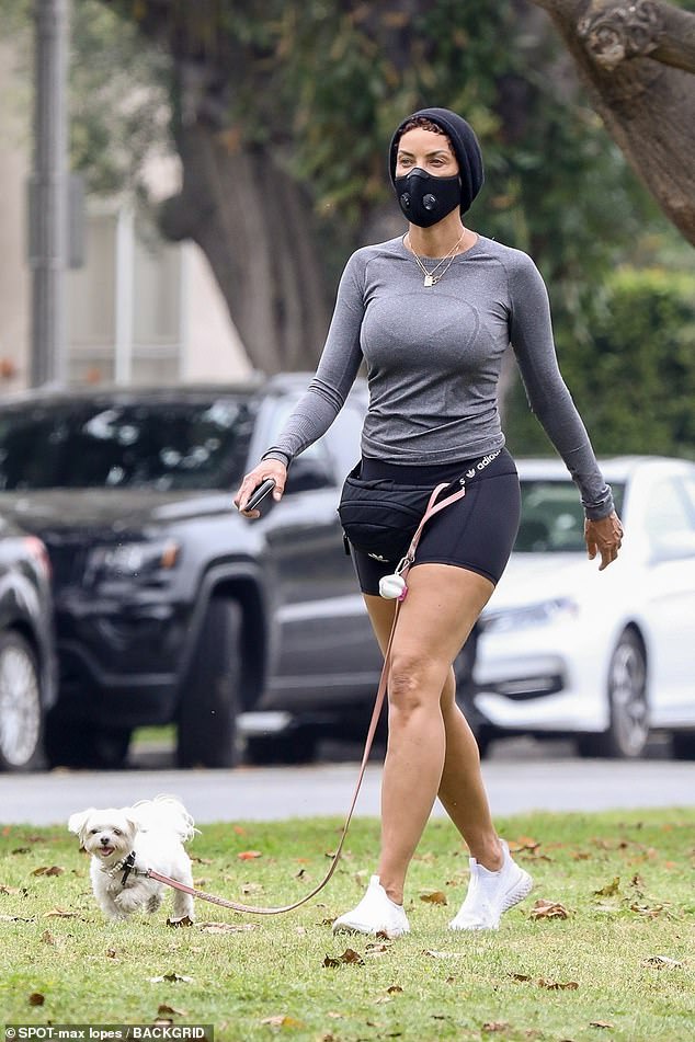 Keeping fit: On Thursday, Nicole Murphy, 52, showcased her toned pins in hot pants as she wore a face mask to walk her pet pooch in Los Angeles, California