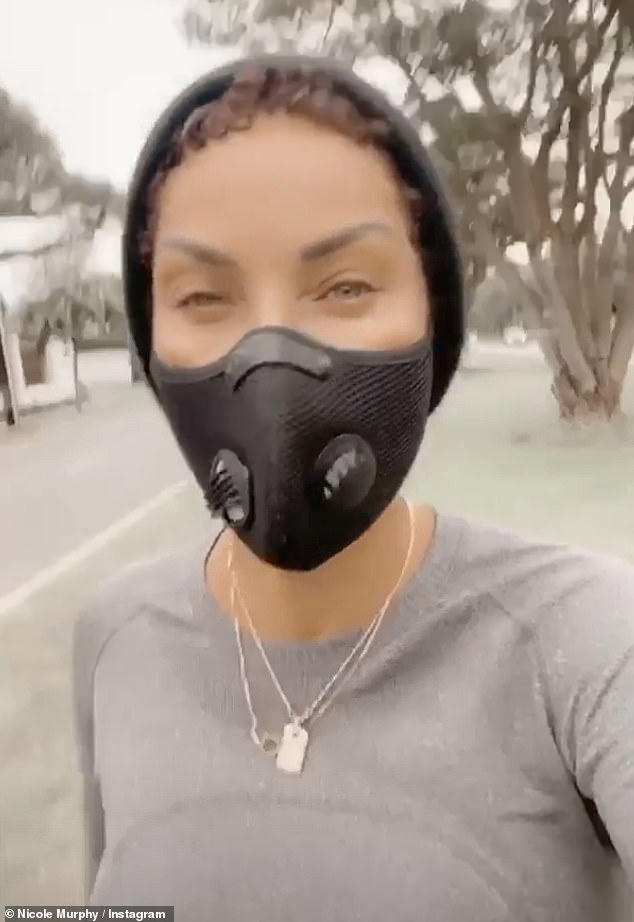 Natural beauty: Nicole went make-up free and left her short dark brown tresses in their naturally curly state beneath a large black beanie