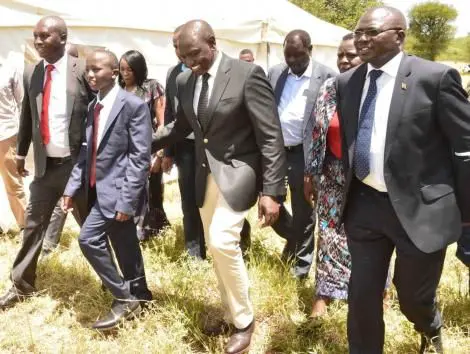 Deputy President William Ruto (second right) with Sergeant Kipyegon Kenei's son (second left) in Nakuru County on Saturday, March 7, 2020