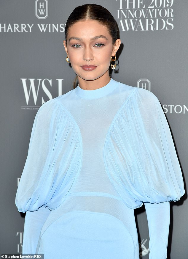 Stay gold: She accessorized with a pair of gold hoop earrings, one of them looped with a diamond ring