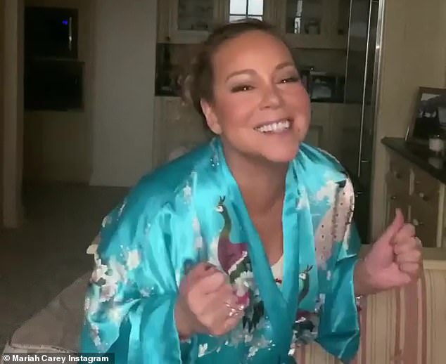 One of her 'favorite album cuts': In the clip, the Honey songstress appeared in a luxurious floral silk robe in powder blue, singing the tenth track from the Mimi album, titled Your Girl