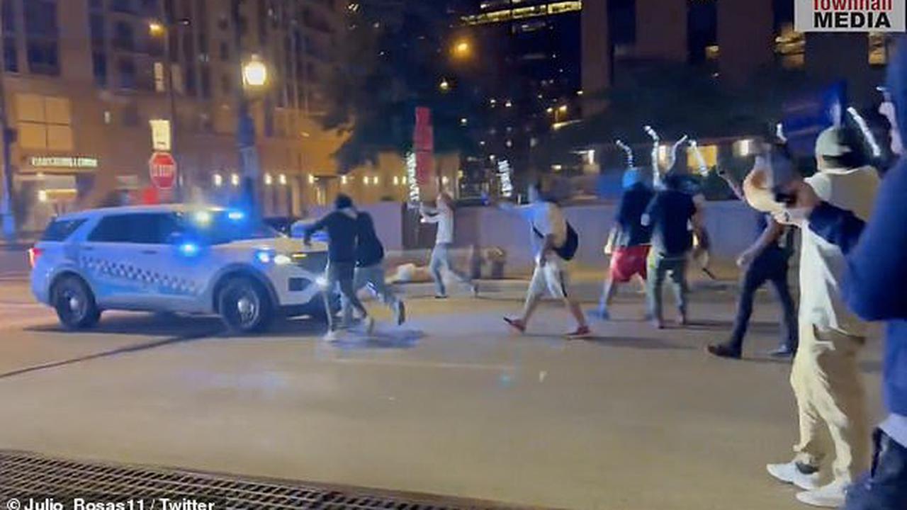 Terrifying moment Chicago street racers attack cops who tried to stop them doing donuts in city's Loop neighborhood -  just hours before July 4 massacre that killed six