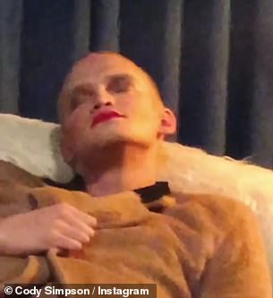 Simpson is made up with dark eye-shadow, rouge and red lipstick