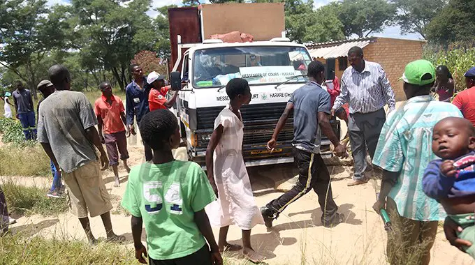 Residents of Watervlei Farm in Chitungwiza block the Messenger of Court truck as they resist eviction from their dwellings yesterday. - Picture: Believe Nyakudjara