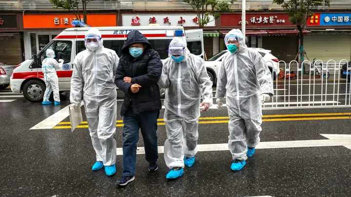 WUHAN, CHINA - JANUARY 26 2020: Medical staff help a patient walk into the hospital in Wuhan in central China's Hubei province Sunday, Jan. 26, 2020.-