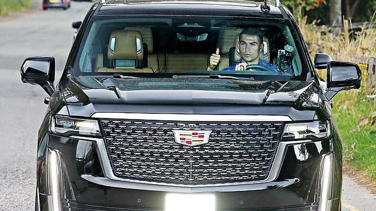Cristiano Ronaldo gives a thumbs up as he leads glum-faced Man United stars arriving into Carrington for the first time since they were all dragged in on their day off to run more than eight miles in 30C heat following Brentford humiliation
