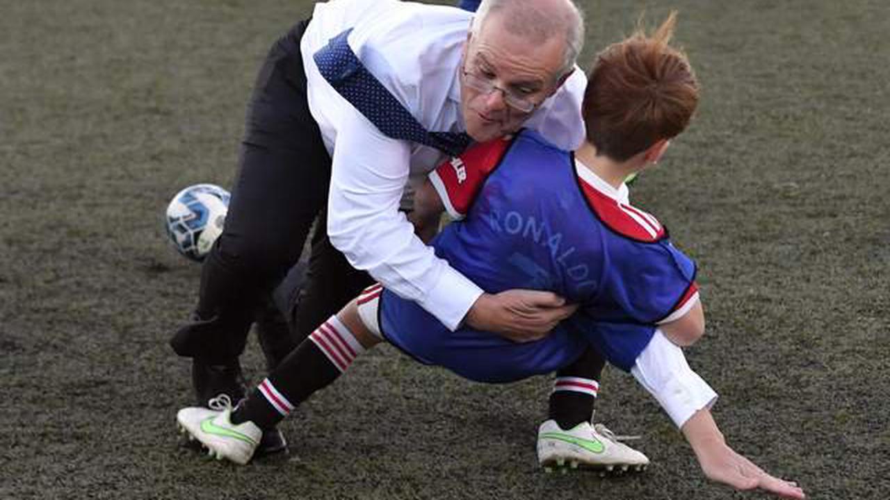 Australian prime minister Scott Morrison rugby tackles child during football match