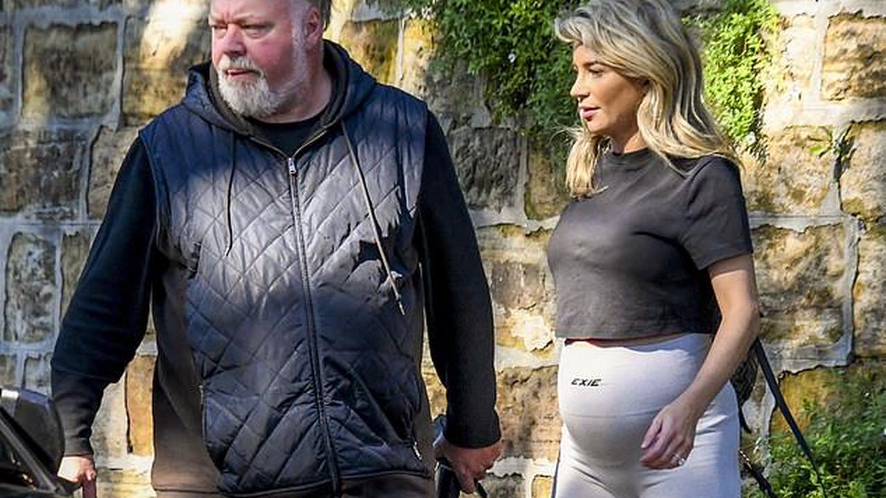 Kyle Sandilands' pregnant fiancée Tegan Kynaston shows off her burgeoning baby bump in skintight activewear as the pair step out together in Sydney