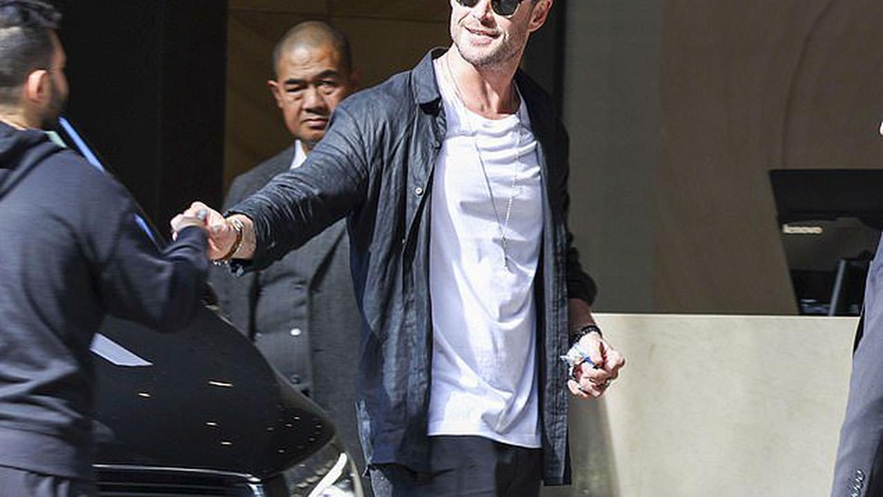 He's still got time for fans! Chris Hemsworth happily signs autographs outside his lavish Sydney Hotel as he steps out with his father Craig