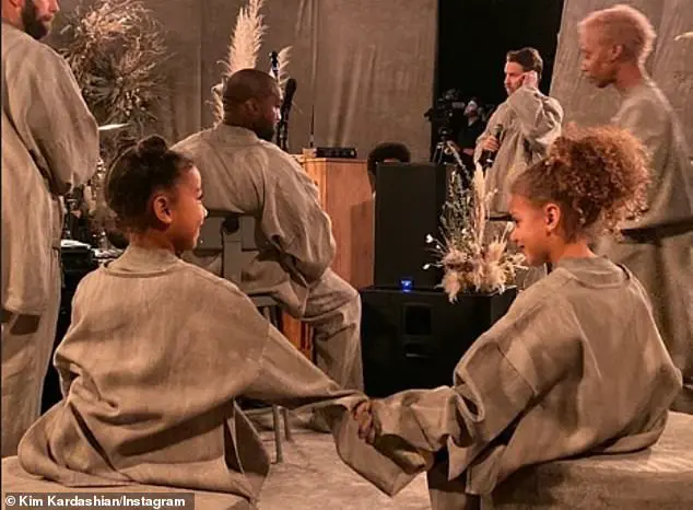 Sweet: Dressed in a matching grey ensemble to her rapper dad, 42, the six-year-old danced in front of hundreds of spectators as Kanye performed Closed On Sunday from his latest album Jesus Is Born (pictured together with North's BFF)