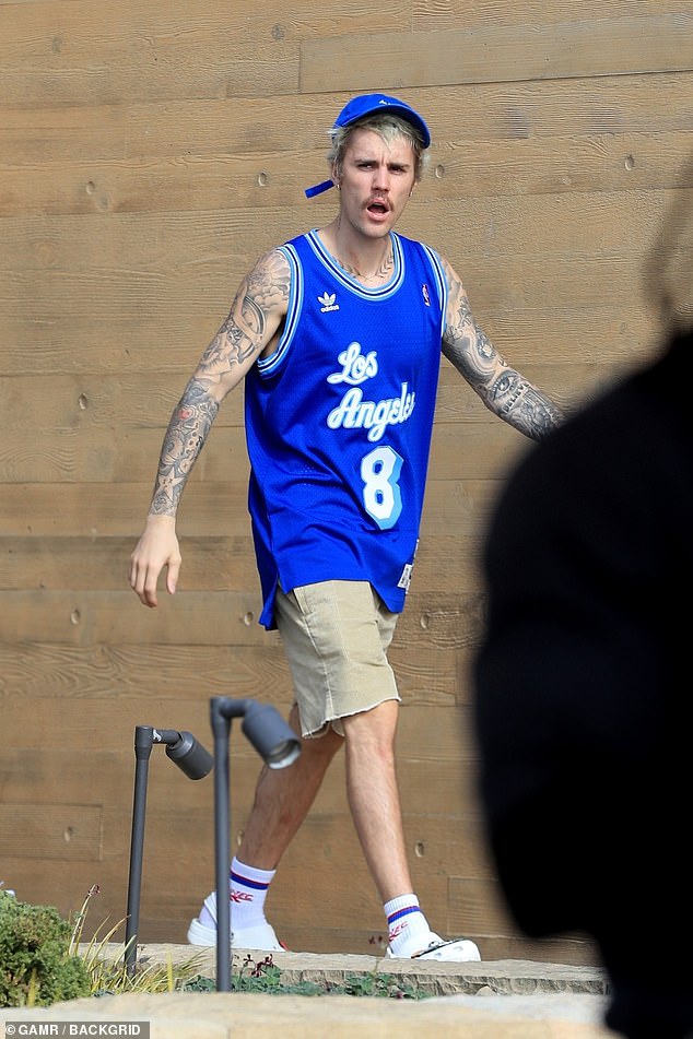 Old school: The Baby singer wore a blue throwback Adidas jersey with Kobe's number eight