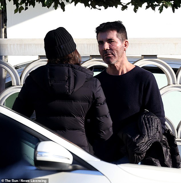 Singer, Simon Cowell engages in a 