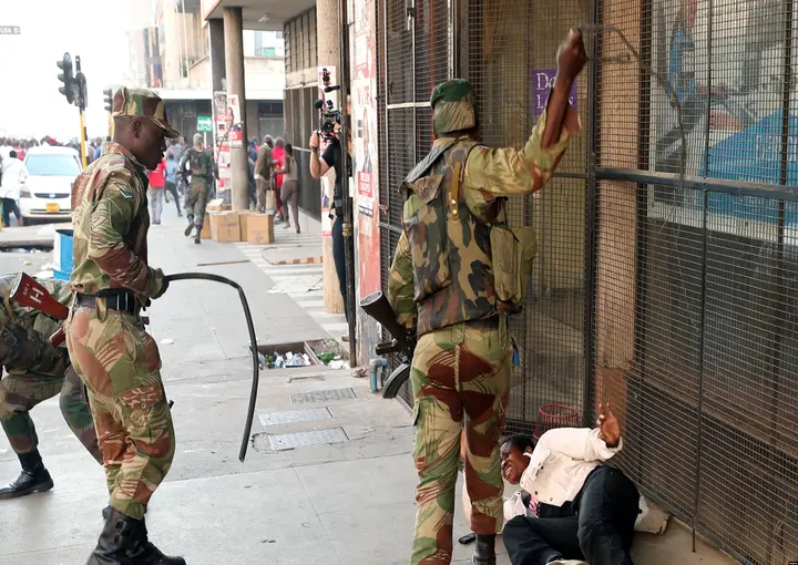 FILE: Soldiers beat a supporter of the opposition Movement for Democratic Change party of Nelson Chamisa outside the party's headquarters as they await the results of the general elections in Harare, Zimbabwe, Aug. 1, 2018.