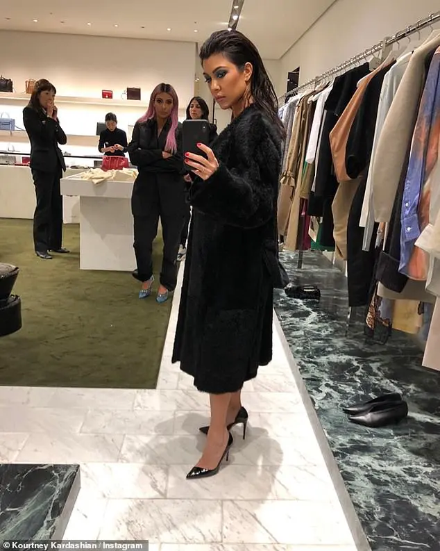 Memories: While Kim appeared to be glaring at her in another snap, Kourtney posed for a mirror selfie with her hair slicked back, turquoise eyeshadow and a furry black coat