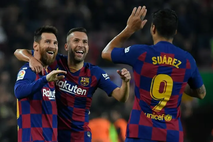 Barcelona's Argentine forward Lionel Messi (L) celebrates his goal with Barcelona's Spanish defender Jordi Alba and Barcelona's Uruguayan forward Luis Suarez during the Spanish league football match between FC Barcelona and Real Valladolid FC at the Camp Nou stadium in Barcelona on October 29, 2019. (Photo by LLUIS GENE / AFP) (Photo by LLUIS GENE/AFP via Getty Images)