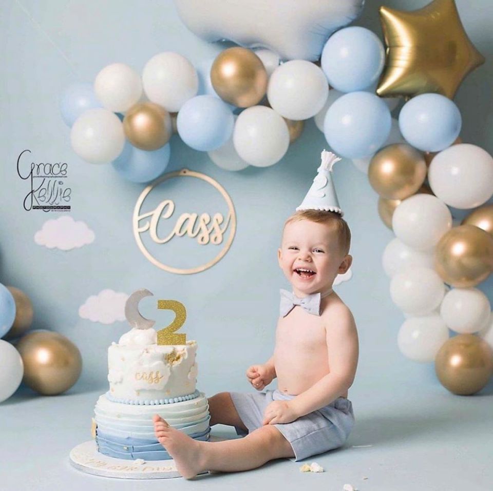 In the set shared online, Cass can be seen smiling happily next to the untouched two-tiered cake before digging in