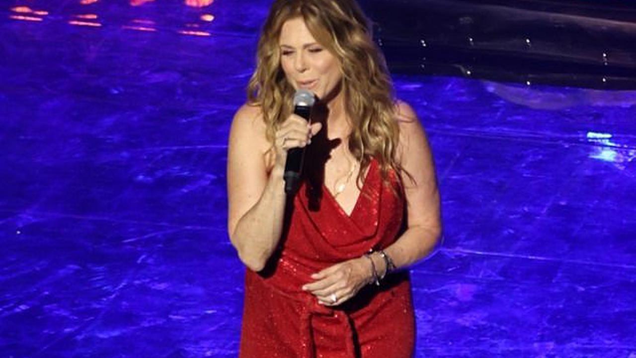 Rita Wilson rocks a glittery red gown during a performance in Greece as husband Tom Hanks' film Elvis beats out Top Gun sequel at the box office