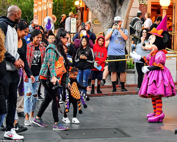 Fellow visitors at Disneyland took snaps of the basketball legend and his family strolling along