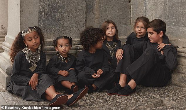 Kiddie cuddle: The reality celebrity, 40, also shared this snap of her and sister Kim's children from left,  North, six, Chicago, one, Saint, three, Penelope, seven, Reign, four, and Mason, nine