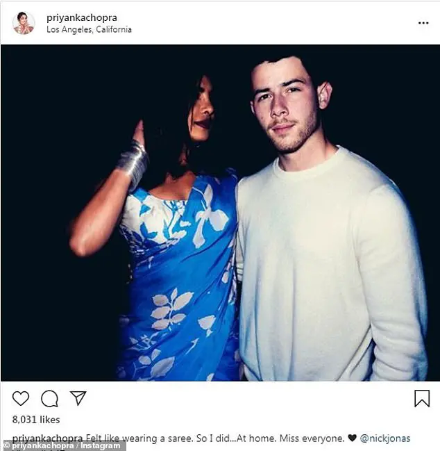 Getting dressed up: On Sunday, she shared a photo of herself and Nick with the caption: 'Felt like wearing a saree. So I did...At home. Miss everyone'