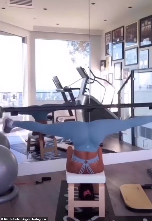 Stretch: As the star thrust her lean legs in the air, she then moved into the splits position with ease, before repeating the movement again