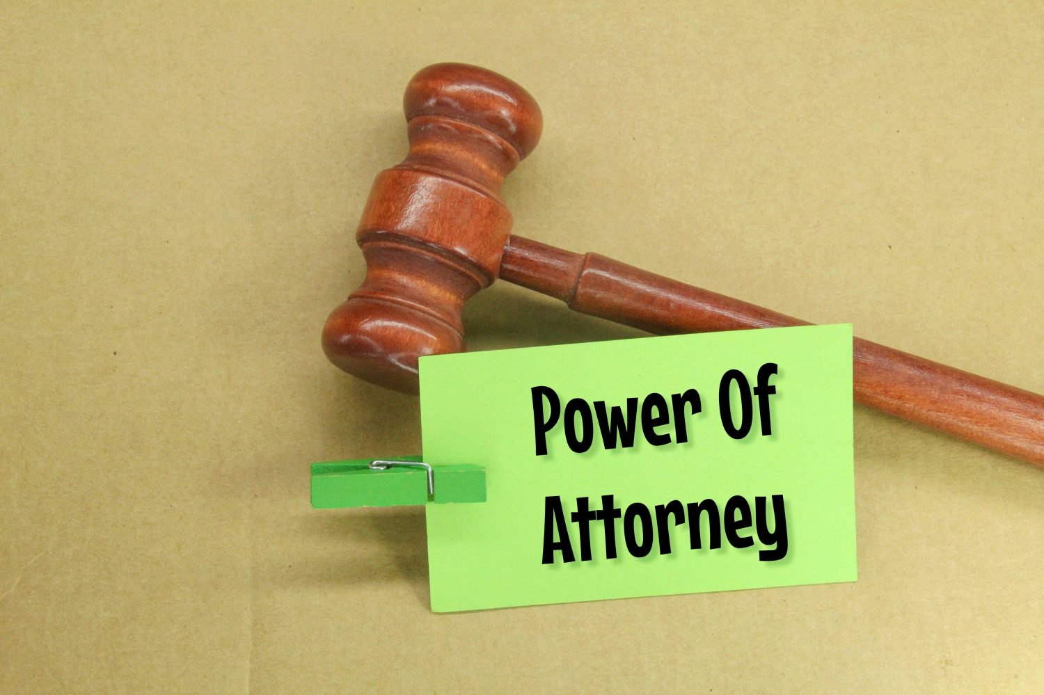 hammer hammers and colored paper clamped with the word power of attorney
