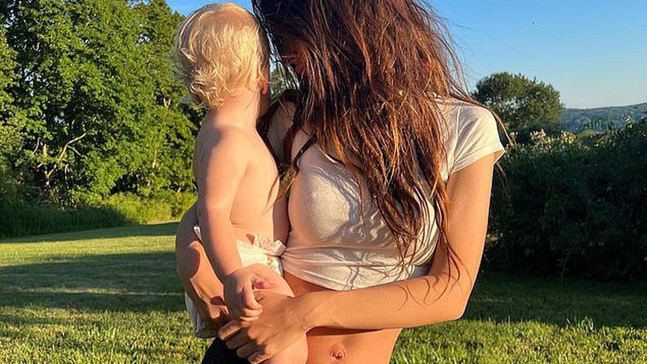 Emily Ratajkowski exhibits her toned physique in a white crop top as she dotes on son Sylvester, 17 months, after split from husband Sebastian Bear-McClard