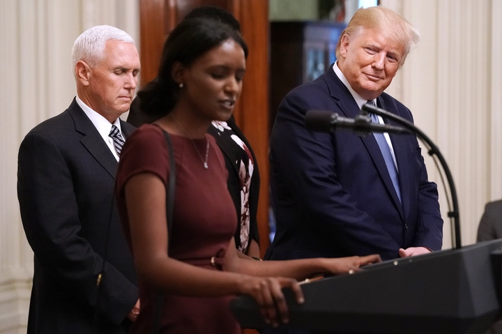 President Donald Trump (R) listens as a woman he invited on stage prays with Vice President Mike Pence during an event for the Young Black Leadership Summit in the East Room of the White House October 04, 2019 in Washington, DC. Organized by the conservative nonprofit political group Turning Points USA, the summit bills itself as a professional development, leadership training and networking opportunity. Chip Somodevilla/Getty Images