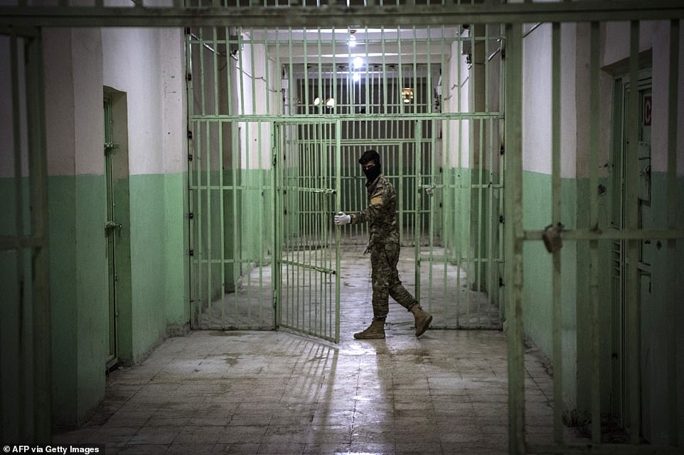 A member of the SDF stands guard. Some of the detainees are teenagers, and none of them have been under the sun even once in months or more