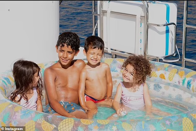 Shirtless Cristiano Ronaldo relaxes in the sun with girlfriend Georgina Rodriguez and his children during boat trip in Majorca (photos)