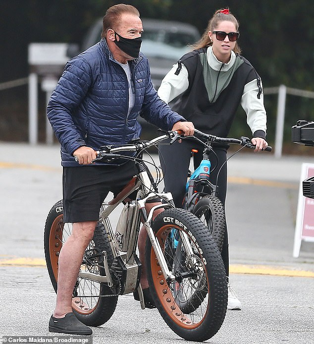 Meanwhile: Christina bundled up in a color-block jacket and swept her hair into a ponytail for her day out with her father