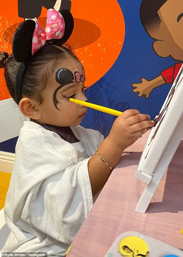 Painting her masterpiece: Her aunt Kylie Jenner shared photos of Chicago hard at work on a painting while wearing Minnie Mouse ears, with a second set painted on for good measure