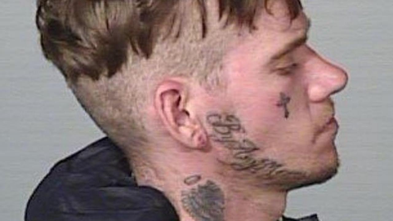 Australian criminal with 'blessed' and 'by any means' tattooed on his neck is on the run - and police need your help to find him