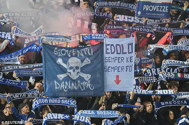 Brescia fans hold scarves and light flares inside Stadio Mario Rigamonti
