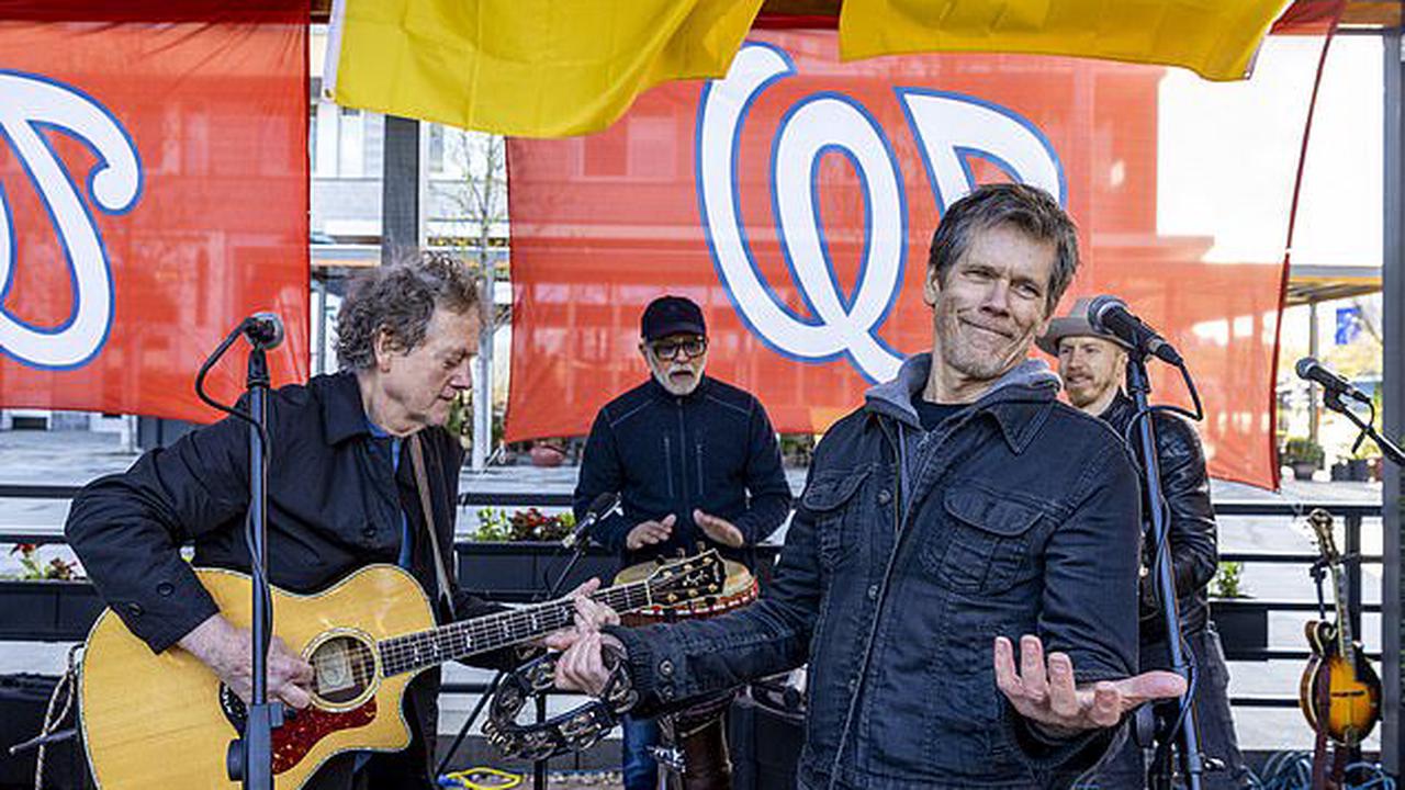 Kevin Bacon and his brother Michael of The Bacon Brothers play a benefit concert for Ukrainian refugees at Dacha Beer Garden in Washington, D.C.