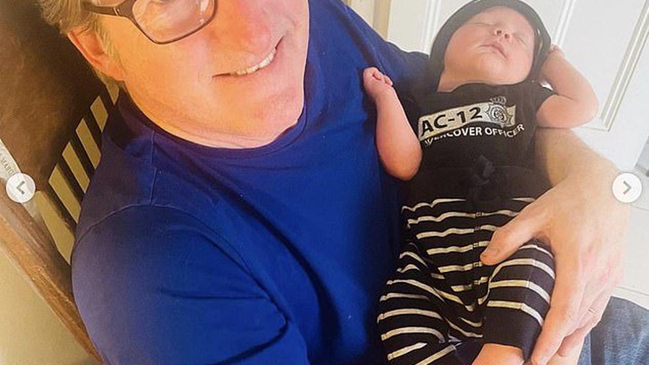 Line Of Duty's Adrian Dunbar, 63, cradles his newborn granddaughter Zephyr while she sports an adorable AC-12 babygrow in sweet snaps