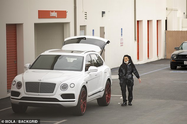 Luxury: The star, 31, wore her Chanel trainers with her paint-splattered stylized sweatsuit set while rocking perfectly applied makeup on Tuesday