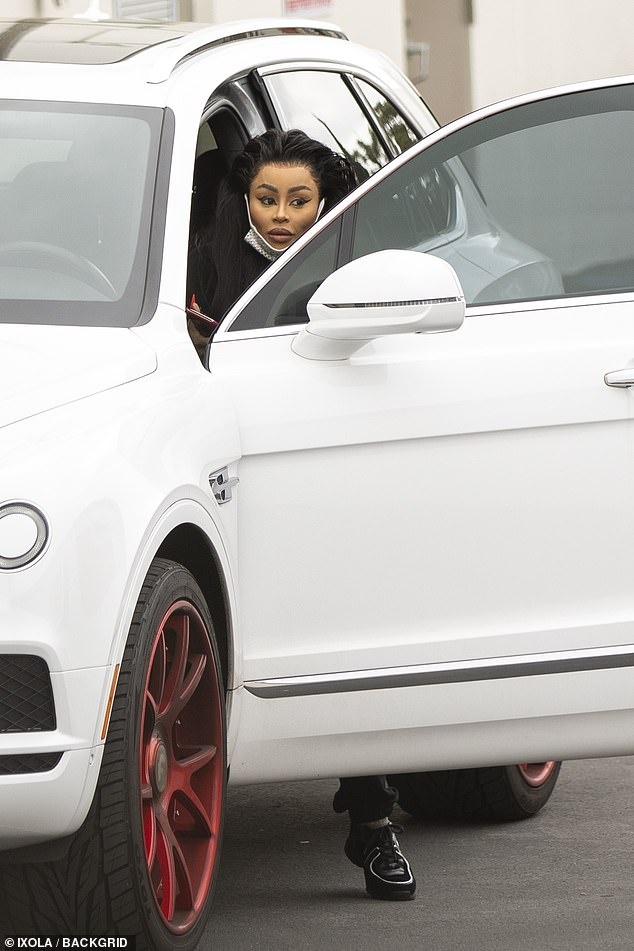 Arrival: Chyna, who was born Angela White, chose black and white sweat bottoms with a matching hoodie - featuring a paint-splattered look